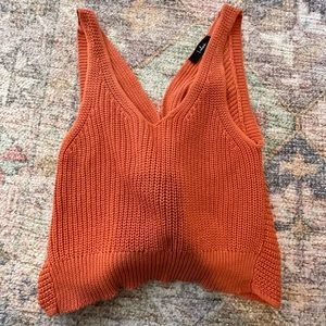 Orange sweater tank with a cross in the back
